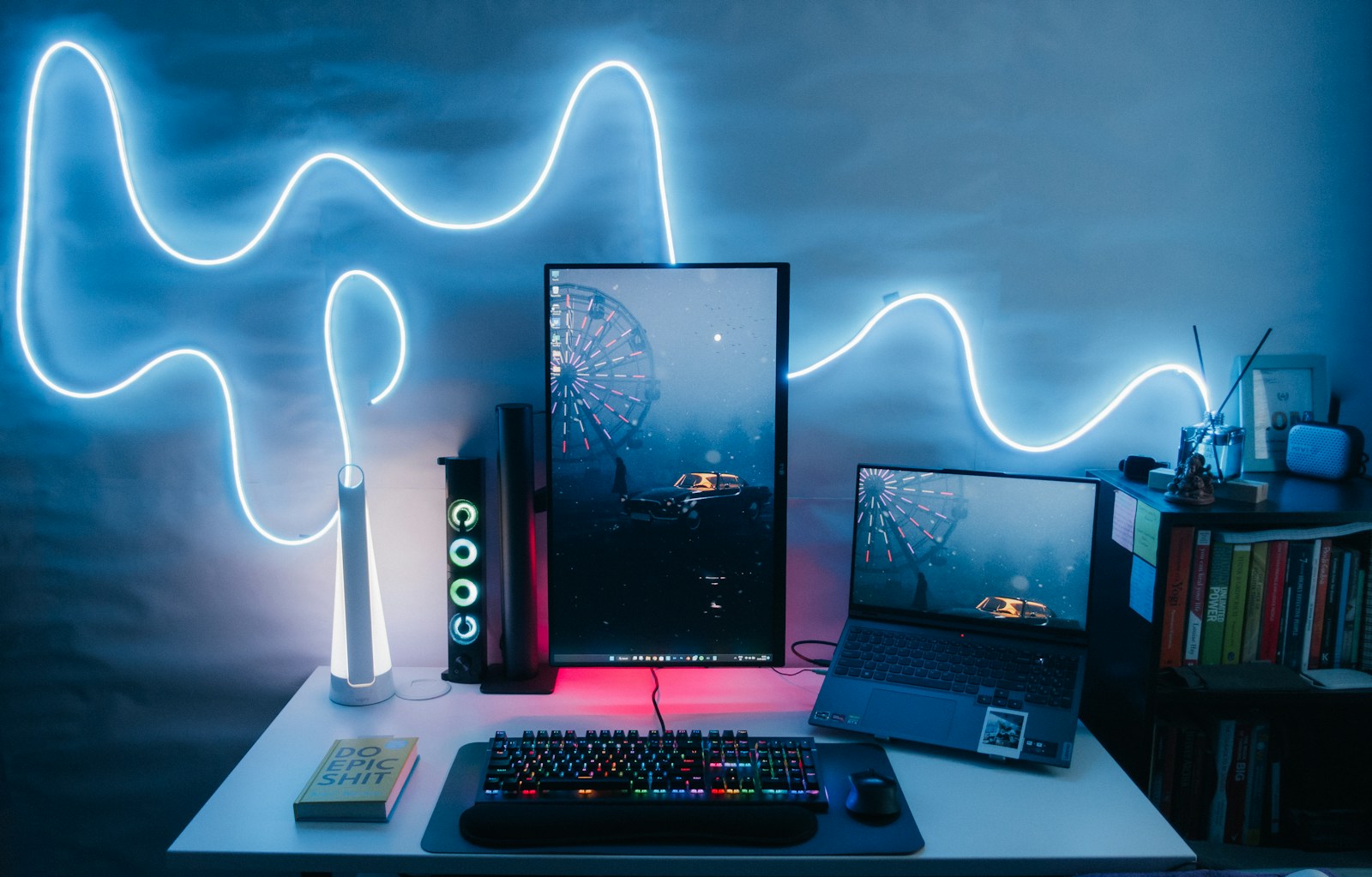 a desk with a keyboard, monitor, mouse and other items